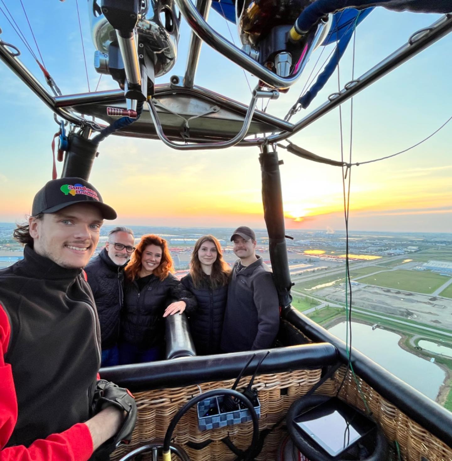 Hot air balloon being prepared for takeoff at sunrise