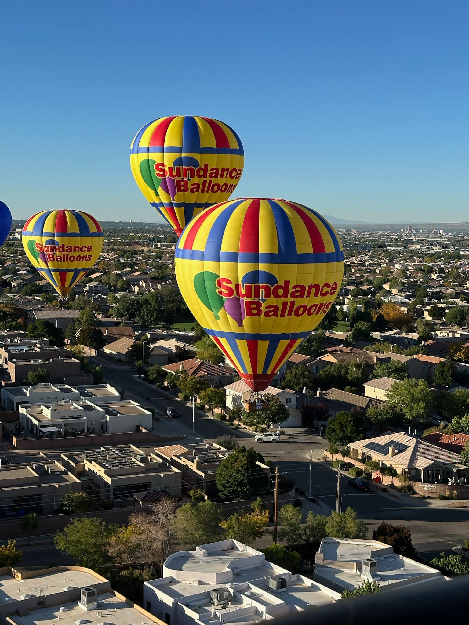 Passengers looking up at a colourful balloon canopy from the basket